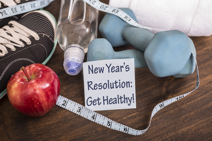 New Year's Resolution, hand weights, measuring tape, apple, sneakers and towel.